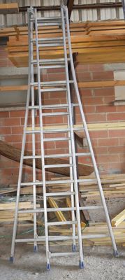 many ladders that are stacked up in a room