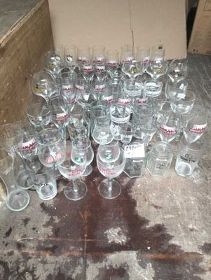 many empty wine glasses sitting on the floor next to a cardboard box