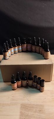 many bottles of essential oils in a box on a table