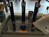 a counter with a bunch of beer taps on it
