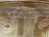 a silver plate with a picture of a horse and a bird on it