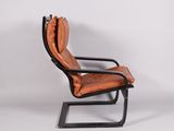 a brown leather chair with a black metal frame on a white background