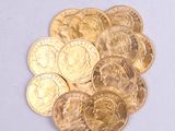a pile of gold coins sitting on a white surface