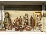 many figurines of different sizes and shapes on a shelf