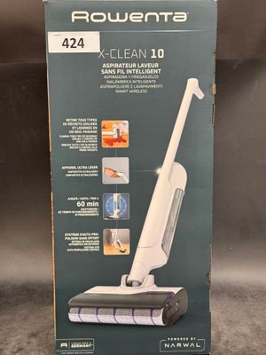 the box of a vacuum cleaner is sitting on the floor