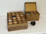 two boxes of cupcakes sitting on a table