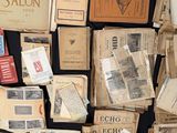 a lot of old papers and old books on the table