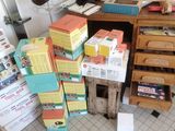 a pile of boxes sitting on the floor next to a desk