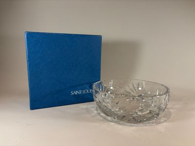 a glass bowl sitting on a table next to a blue box