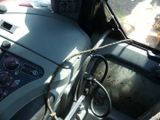 a steering wheel of a truck with a rope on the steering wheel