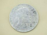 a silver coin with a picture of a woman on it