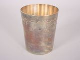 a silver cup that is sitting on a table