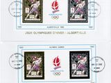two stamps with olympic symbols on them on a white background