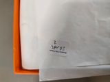 an orange box with a white sticker on it