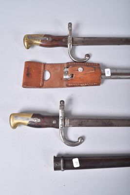 four different types of knives are lined up on a white surface