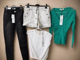 three pairs of black, white, and green clothes hang on a hanger