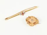 two gold and diamond brooches and a gold pin