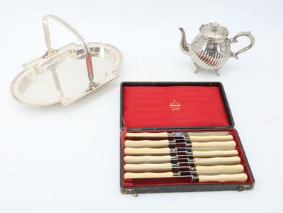 a silver tray with a tea set and a silver teapot