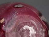 a close up view of a red glass vase