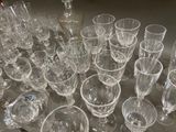 a lot of empty wine glasses and a bottle on the table