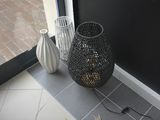two vases sitting on the floor next to a door