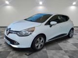 a white car is parked in a room with a checkered floor