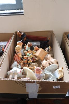 two boxes with figurines in them sitting on a table