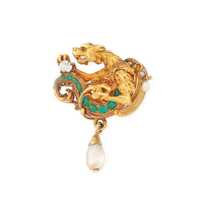 a close up of a broochle with a dragon and a pearl