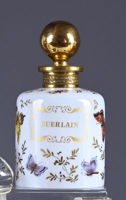 an image of a bottle of perfume sitting on top of a table