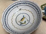 a bowl with a bird on it sitting on a table