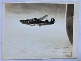 an old photo of a small plane flying in the sky