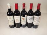 six bottles of red wine are lined up on a counter