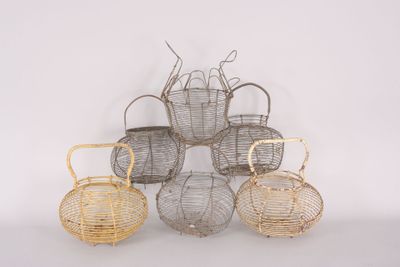 four baskets are stacked on top of each other on a white surface