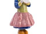 a figurine of a woman holding a piece of paper