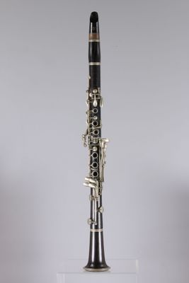 a close up of a clarinet on a clear surface