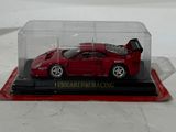 a red toy car in a clear case on a table
