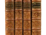 un ensemble de quatre vieux livres superposés