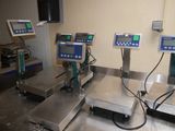 several electronic weighing machines are sitting on a table in a room