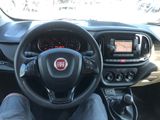 a man sitting in the driver ' s seat of a car