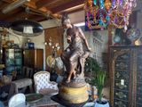 a statue of a woman sitting on a pedestal in a room