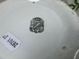 a white plate with a black and white emblem on it
