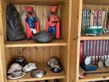 a wooden bookcase with many different items on top of it