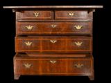 an antique chest of drawers with brass handles and a wooden top