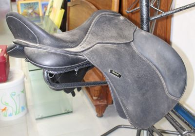 a saddle that is sitting on a stand in a room
