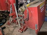 a red machine that is sitting in a garage