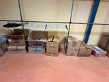 a room with boxes and a rack with clothes on it