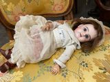 a doll that is laying on a chair in a room