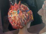 a painting of a woman ' s head in a glass case