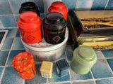 many different containers and tins on the counter