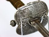 a close up of a sword with a metal handle